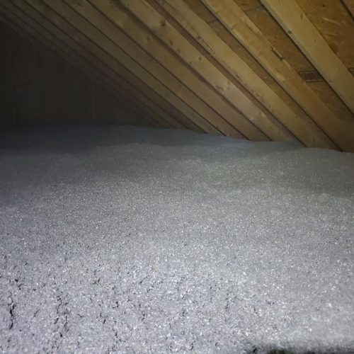 A layer of cellulose insulation in an attic